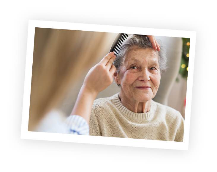 carer-brushing-elderlt-womans-hair